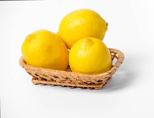 istock Three lemons in a basket on a white background 2169704637