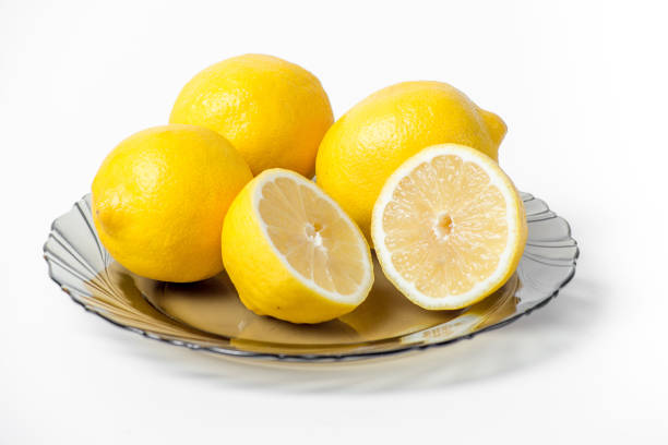 Three lemons in a basket on a white background
