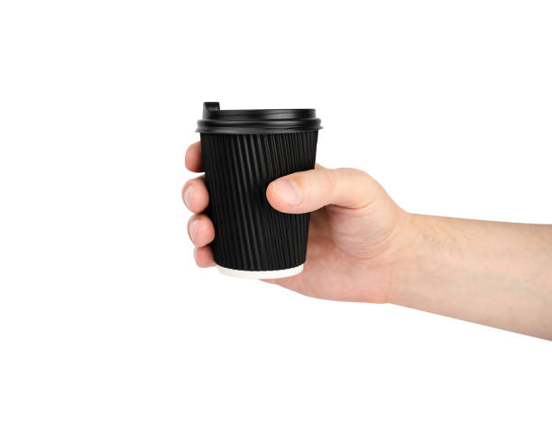 istock Man's hand holds a disposable paper cup with fresh coffee isolated on a white background. 2169709179