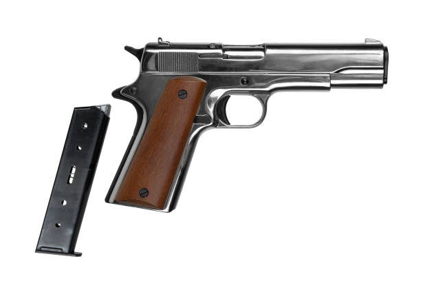 istock A small silver pistol with a wooden handle. Short-barreled weapon. Modern semi-automatic pistol isolate on a white background. 2169709790