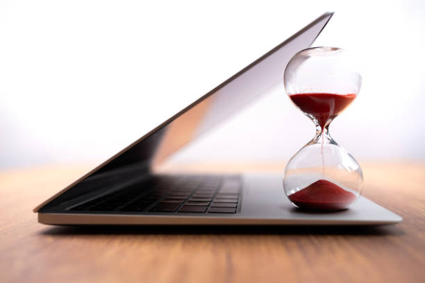 istock Laptop with hourglass – Visualization of time management and deadlines 2169710281