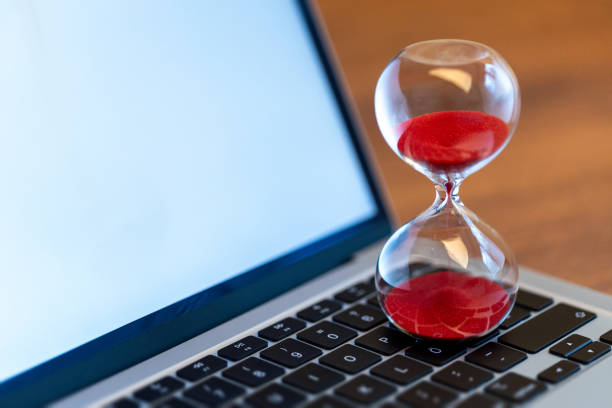 istock Laptop with hourglass – Visualization of time management and deadlines 2169711533