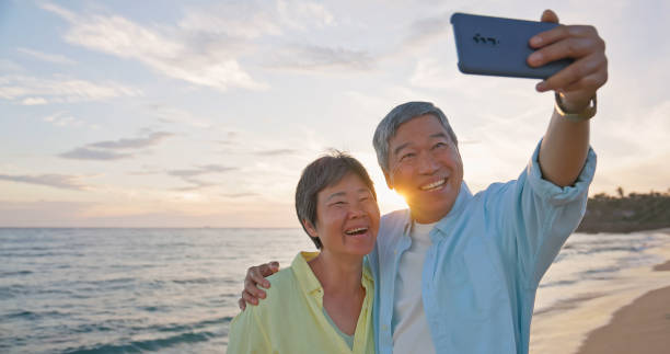 istock elderly couple selfie seaside happy 2169711820