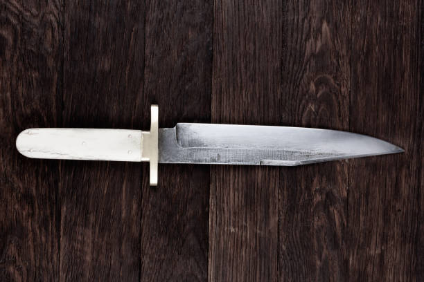 istock Old west bowie knife on wooden deck 2169717752