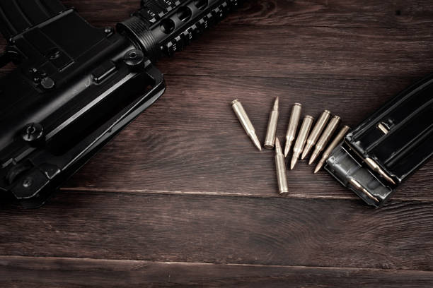 istock Rifle and Ammunition with magazine on wooden table 2169717912