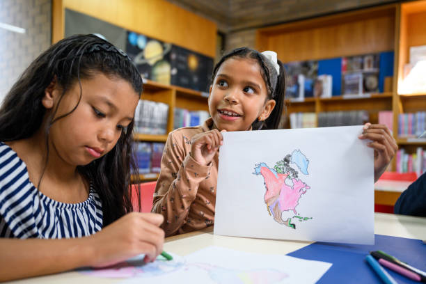 istock Children colouring in and making a world map together 2169720188