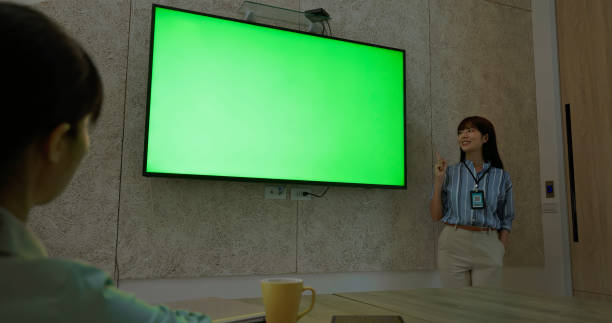 istock businesswoman present with green screen 2169720496