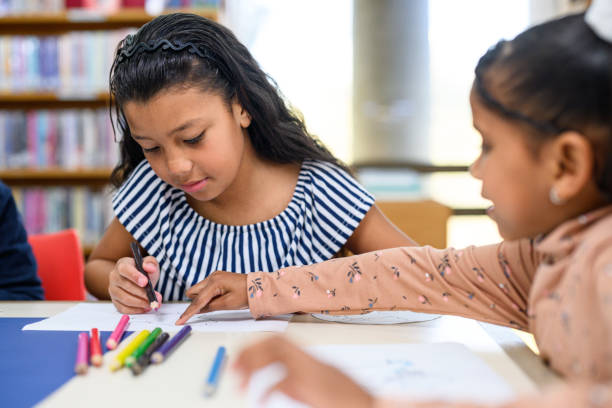 istock Children colouring in and making a world map together 2169720627