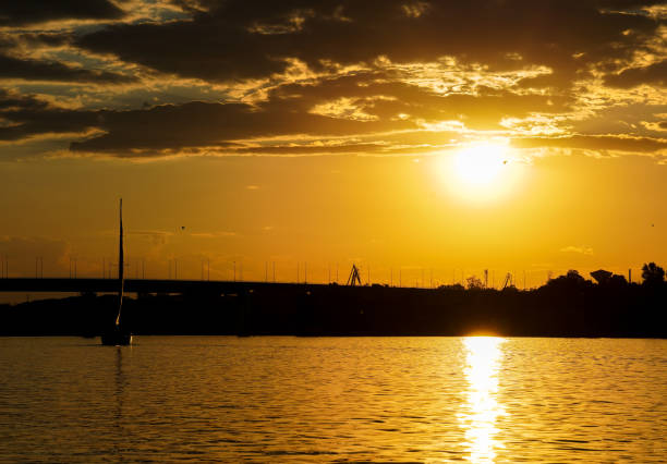 A wonderful enchanting scenery of a boat going back to the dock at sunset
