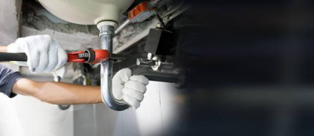 istock Technician plumber using a wrench to repair a water pipe under the sink. Concept of maintenance, fix water plumbing leaks, replace the kitchen sink drain, cleaning clogged pipes is dirty or rusty. 2169727285
