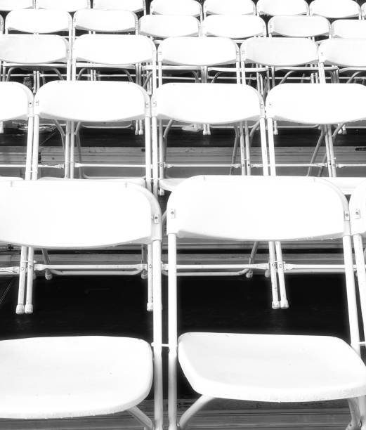 istock Rows of White Folding Chairs in the Stands 2169733146