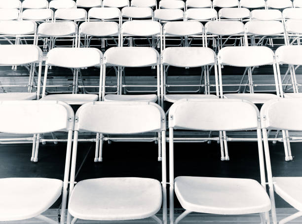 istock Rows of White Folding Chairs in the Stands 2169733161