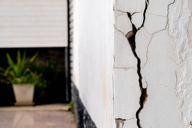 istock Cracked concrete wall broken wall at the outside cement corner that effected with earthquake and collapsed ground 2169733773