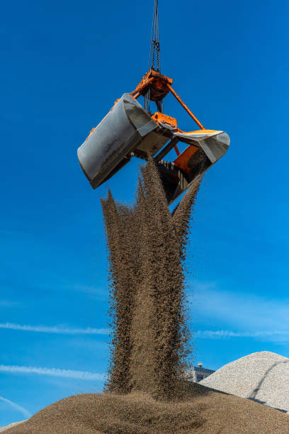istock Grab crane fills sand on a hill 2169739176
