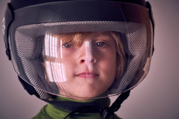 Shot of a little boy wearing a cycling helmet