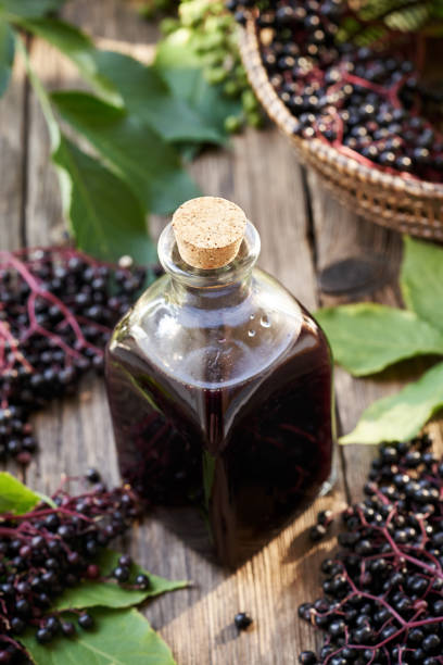 istock A bottle of black elder syrup with fresh elderberries and leaves 2169741009