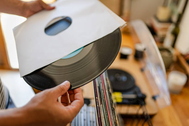 istock Millennial man choosing Vinyl record from his collection 2169741065