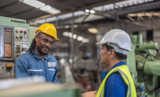 istock Industrial Workers Shaking Hands in Factory 2169742685