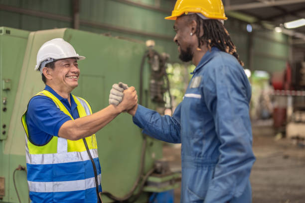 istock Industrial Workers Shaking Hands in Factory 2169742857
