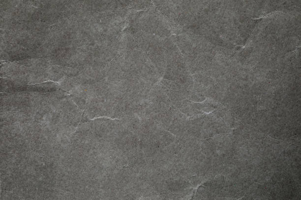 istock Crumpled dark grey paper background texture 2169743039