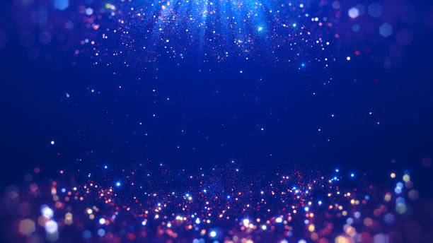 Bright dark blue abstract background with sparkling bokeh effect and light particles of different sizes and colors.