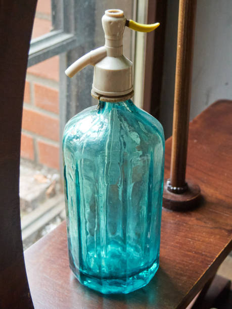 part one of white open glass bottle  on a green background