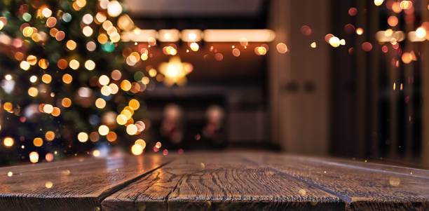 Wooden background with blur effect. Christmas tree and garland lights