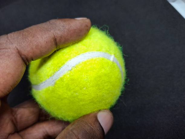 istock A tennis ball is a pressurized, rubber sphere covered in bright, felt fabric. It’s designed for high bounce and durability, used in tennis matches to be hit back and forth. 2169757662