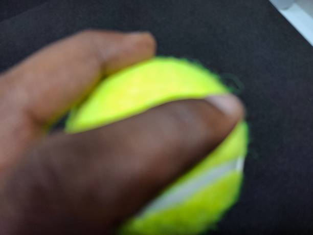 A tennis ball is a pressurized, rubber sphere covered in bright, felt fabric. It’s designed for high bounce and durability, used in tennis matches to be hit back and forth.