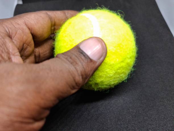 istock A tennis ball is a pressurized, rubber sphere covered in bright, felt fabric. It’s designed for high bounce and durability, used in tennis matches to be hit back and forth. 2169757911