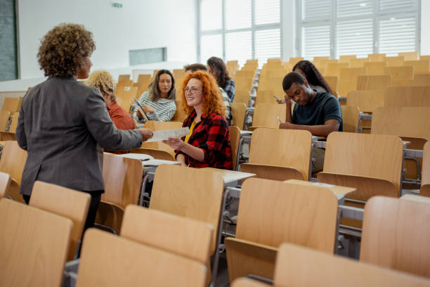 istock Teacher Handing Over Test Results to Her Students 2169760007