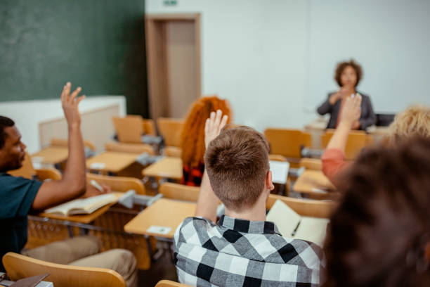 istock Group of College Students Raising Hands to Answer Teacher's Question 2169760012