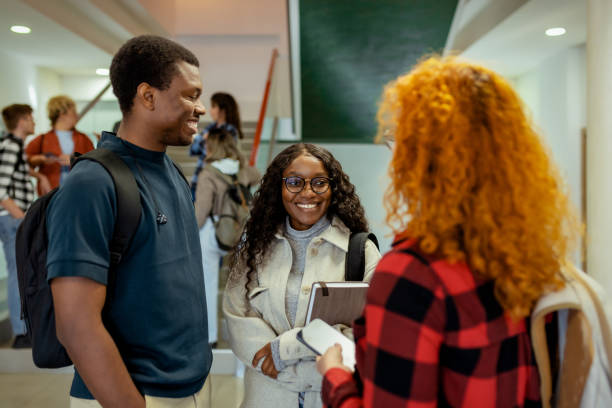 istock Smiling Diverse College Students in Building Corridor Talking After Lecture 2169760065