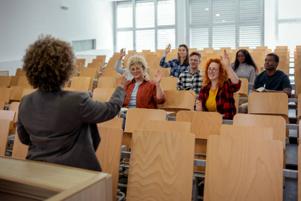 istock Group of College Students Raising Hands to Answer Teacher's Question 2169760267