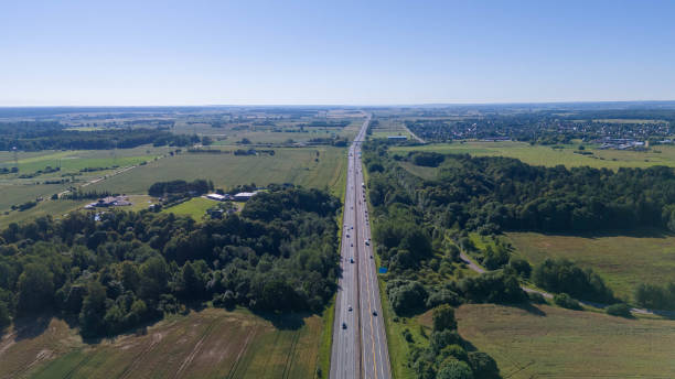 istock Aerial View of Highway Through Lush Forest 2169762715