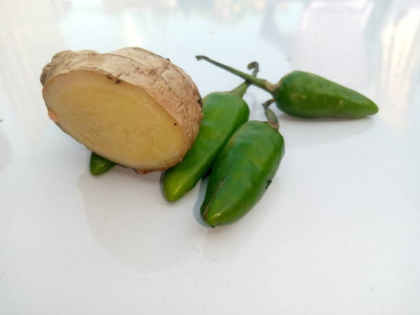 istock Green chilli and bitter gourd background white 2169764145