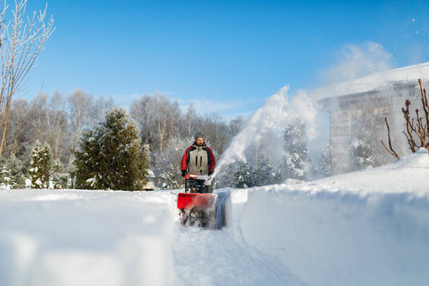Mid adult man using snowblower after heavy snowfall at backyard