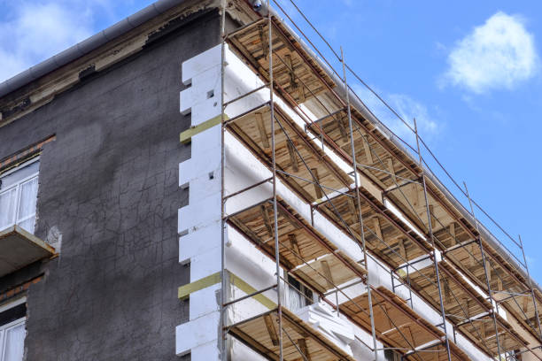 istock Building facade under renovation works with construction scaffolding frame. Wall insulation with styrofoam sheets for energy efficient home 2169766894