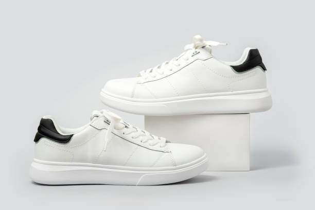 istock White leather sneakers on gray background 2169767847