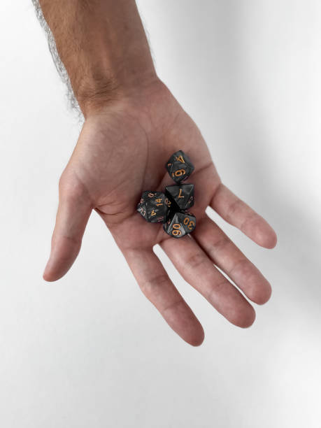 Hand holding dungeons and dragons dice on white background