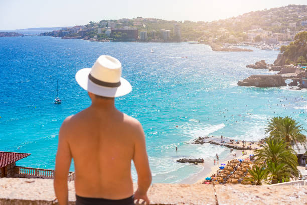 istock Cala Major Beach and a Spanish Man with a Hat in Mallorca, Spain 2169770248
