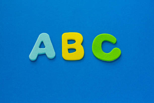 School begginnings. ABC colored letters on blue background, copy space. English for beginners with Copy space.