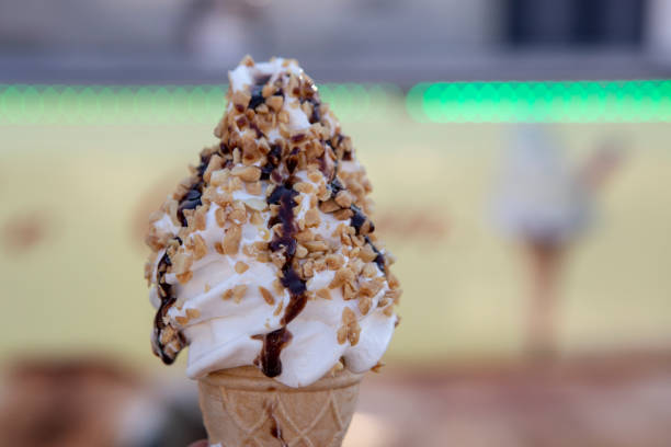 istock Ice cream cone with vanilla ,chocolate and peanuts crumples , soft focus close up 2169776434