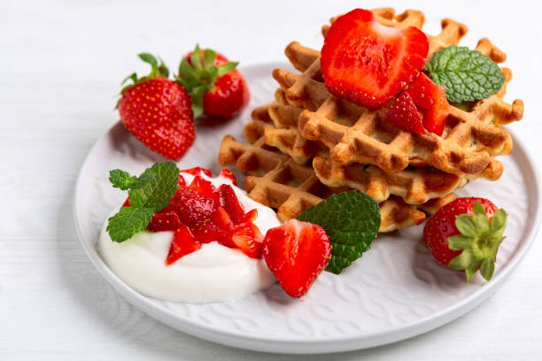 istock Delicious Belgian waffles with strawberries. 2169777401
