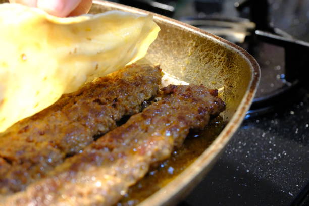 istock Close-up cooking Turkish style Adana kebab and wrapping it with lavash 2169780991