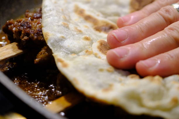 istock Close-up cooking Turkish style Adana kebab and wrapping it with lavash 2169781839