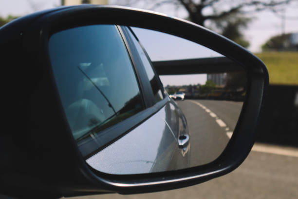 Rearview Mirror Reflection: Cars on a Busy Road