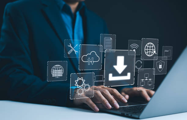 istock Digital Download and Data Storage Technology. Businessman using laptop with digital icons represent data download, cloud storage, networking, and system maintenance. Focus is on technology in business 2169789599