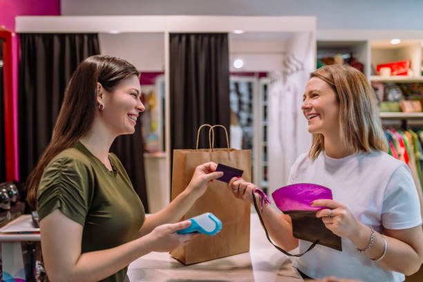 istock woman paying with credit card in store 2169791849