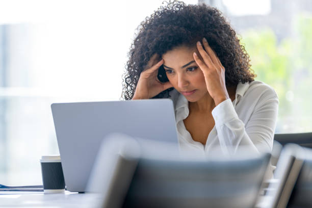 istock Upset woman working on a laptop computer in the office. 2169793234